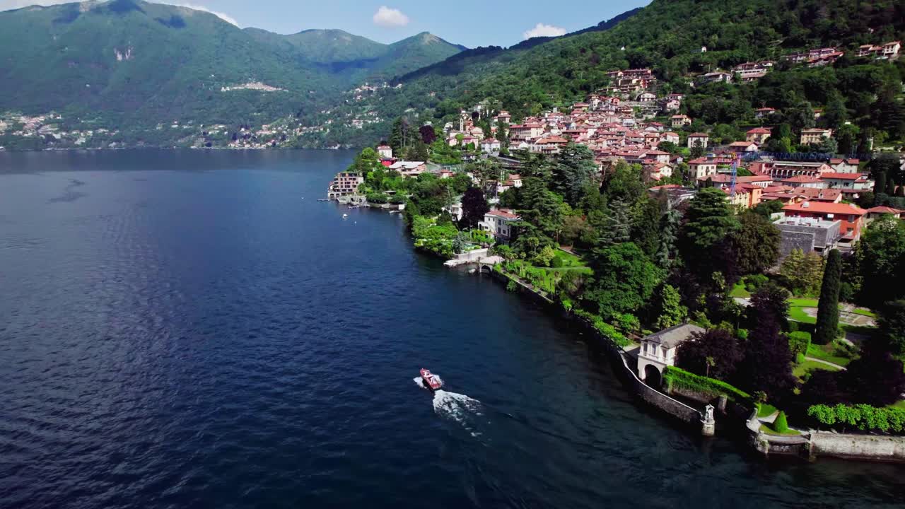 órbita aérea pequeño barco de crucero más allá de torno en el lago de como, italia