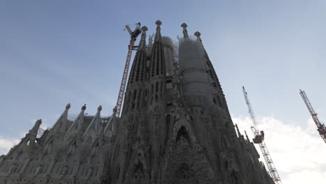 iconic la sagrada familia basilica with cranes and scaffolding in barcelona spain