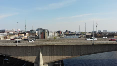 busy car traffic on city central bridge, over clyde river in glasgow united kingdom, aerial 4k