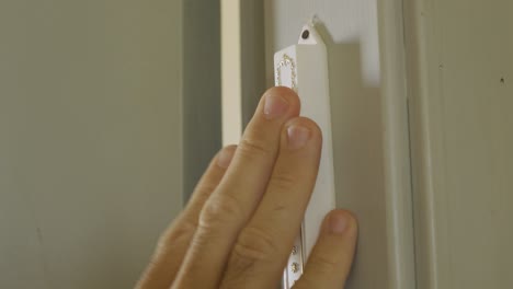 extreme close up - hand touches a jewish door keeper - mezuzah