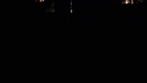 low-angle, dynamic shot of a person’s feet walking down the street in the middle of the night as a city streetlight has short-circuited and is flashing ominously.