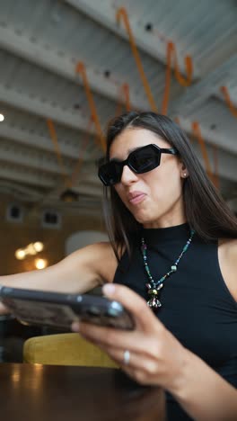 woman eating and using phone in a cafe