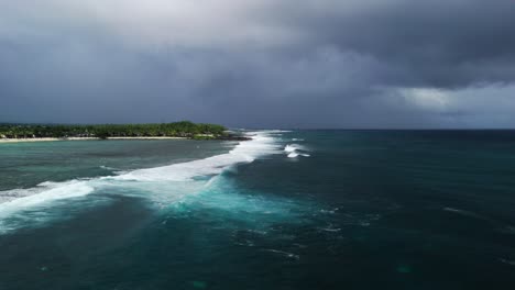 powerful waves crash along st. felix beach under dramatic storm clouds, revealing the wild and untamed energy of mauritius's southern coastline.
