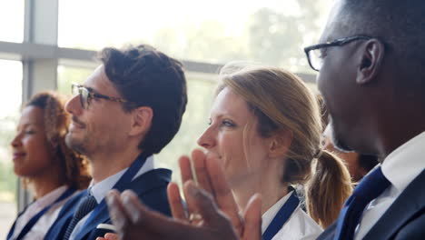 delegates at business conference applauding speaker