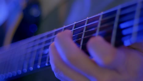 close up shot of musician's hand performing skills on guitar's instrument