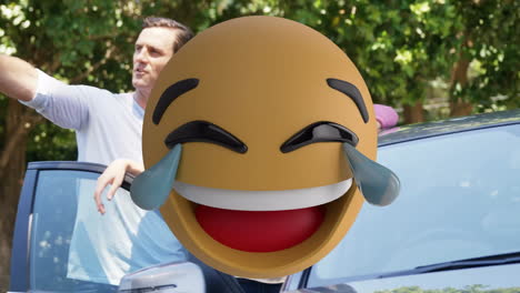 laughing emoji animation with people standing near car in outdoor setting