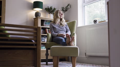 woman sneezing due to allergies at home