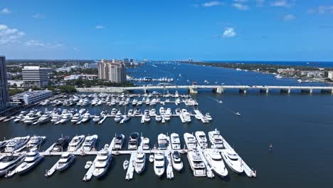 aerial: downtown west palm beach marina with white yachts during the day in florida, usa, pan drone shot