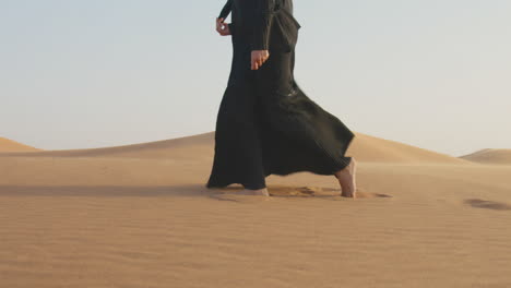 close up of an unrecognizable muslim woman walking barefoot in the desert 2