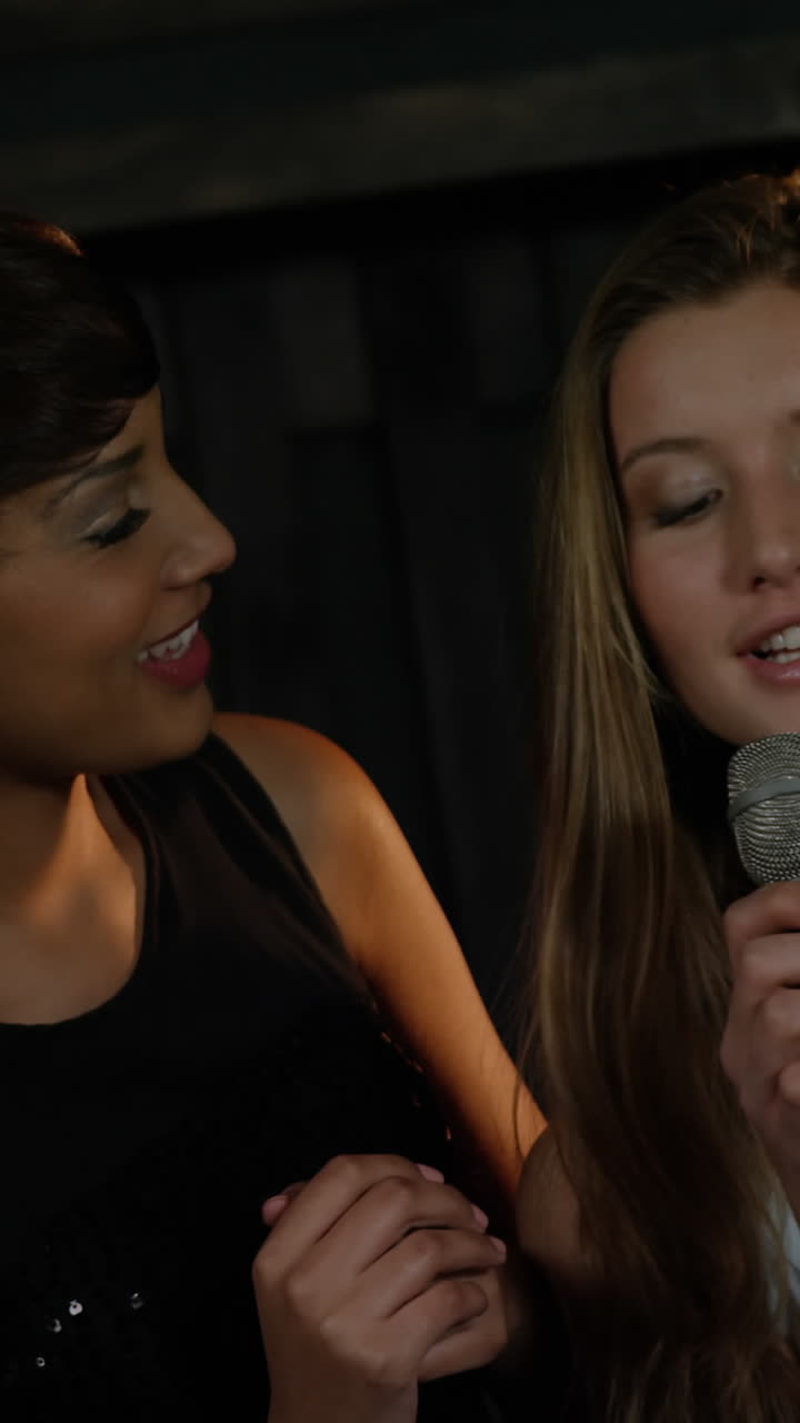 Happy friends singing songs together in bar