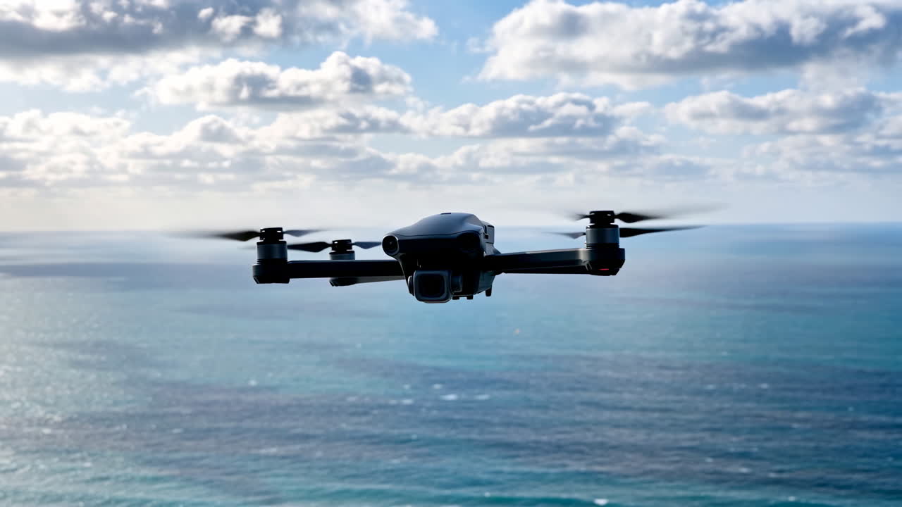 Drone flying over the ocean with clouds in the sky