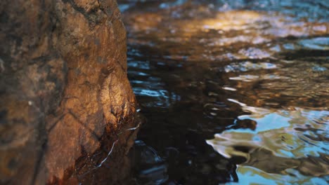 close up on fresh water running in a small creek.