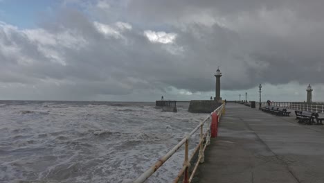 stormy seascape at a lighthouse pier