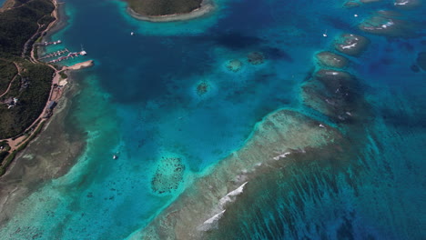 Aerial-View-of-Coral-Reefs-by-Coastline-of-British-Virgin-Islands,-High-Rise-Drone-Shot