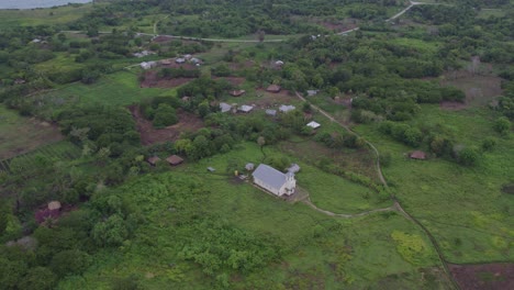 Reveal-shot-of-white-church-at-Sumba-island-during-sunrise,-aerial