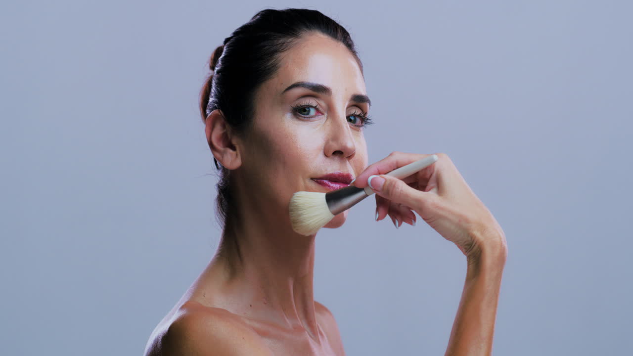 Woman applying makeup with a brush