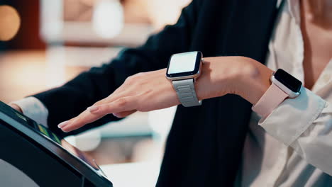 person interacting with a digital device while wearing two smartwatches