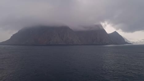 the view of clouds and mist from the deck of a cruise ship sailing along the coast of norway