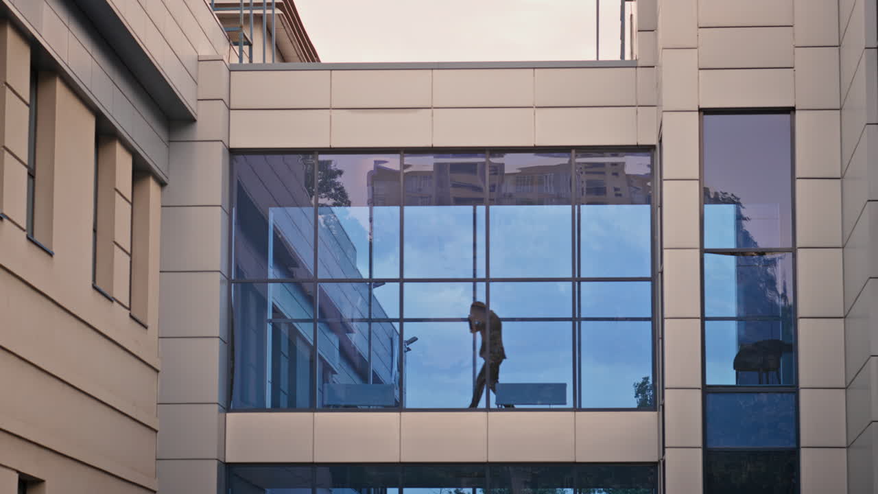 Unknown businessman shouting cellphone gesturing emotionally view from window