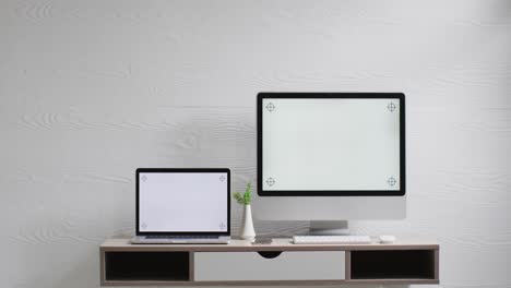 video of computer and laptop on wooden table with copy space in office