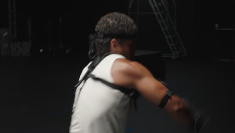 man wearing motion capture suit in studio performing martial arts actor boxing wearing mo-cap suit for 3d character computer game animation for virtual reality fighting gaming