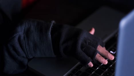 person hacking on a laptop at night