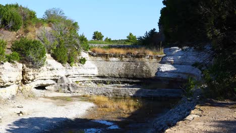 static shot of the spillway at cedar lake in cleburne state park