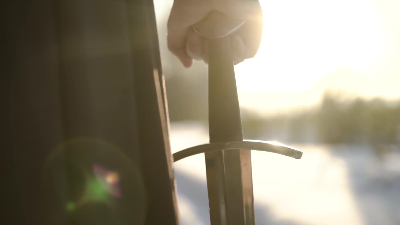 해가 지는 동안 검을 들고 있는 기사