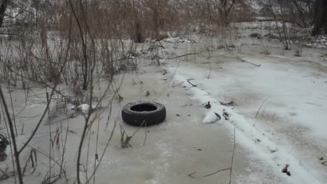 teenager throwing used tire in winter park