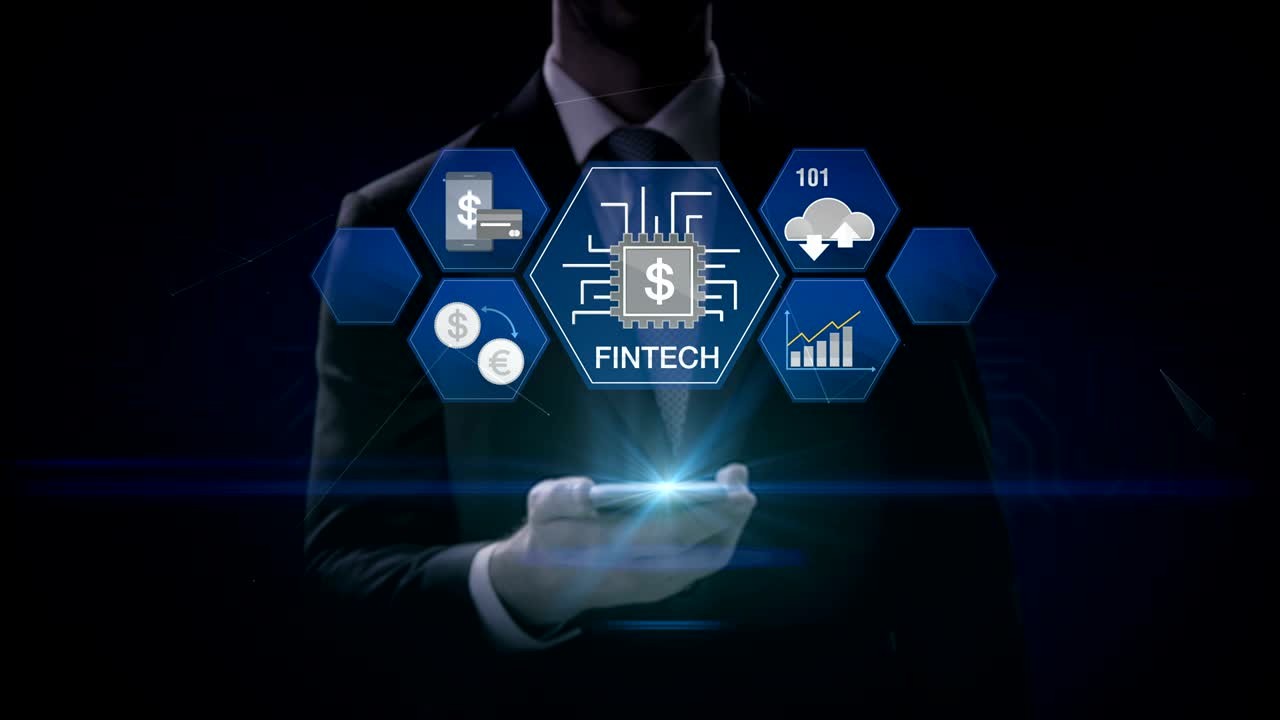 Businessman lifting a smart phone, mobile, Fin-tech icon and various graph. Futuristic financial technology. 4k movie. version 3.