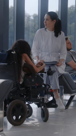 doctor consults a patient in a wheelchair