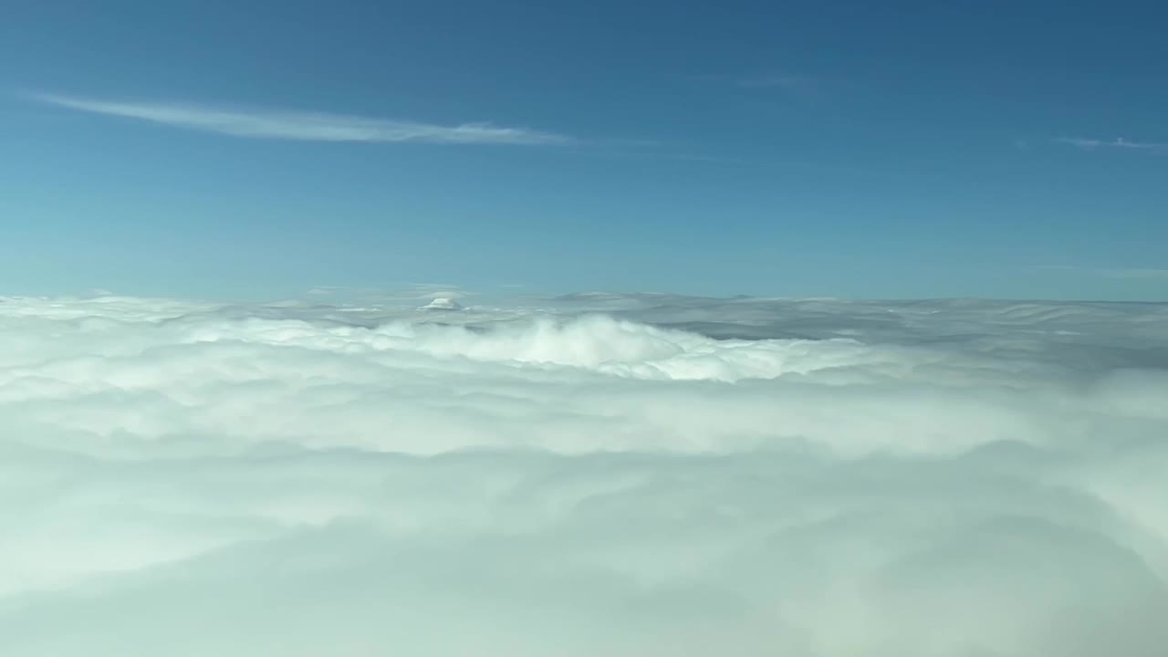 vista aérea de la cabina desde un jet que sobrevuela la parte superior de las nubes durante el día