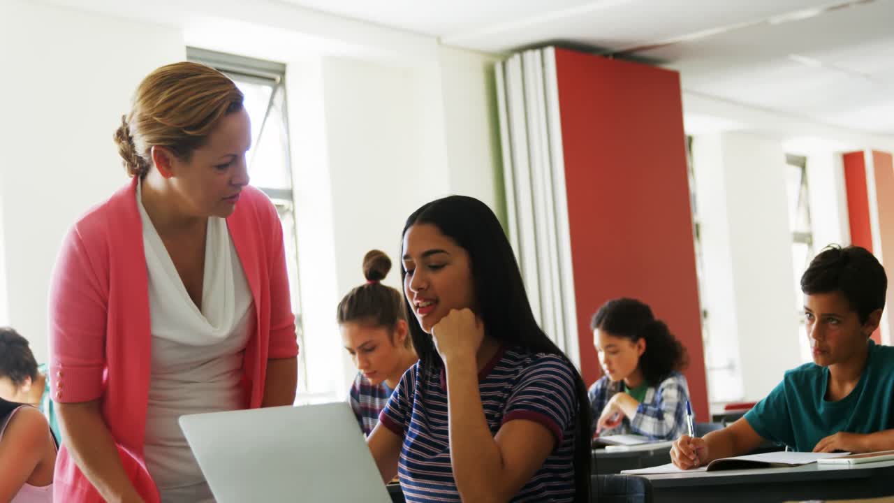 maestro ayudando al estudiante con su tarea en el aula