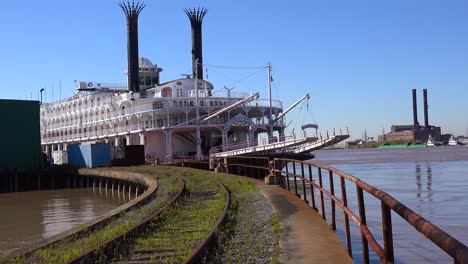 a mississippi riverboat sits at a dock near new orleans louisiana