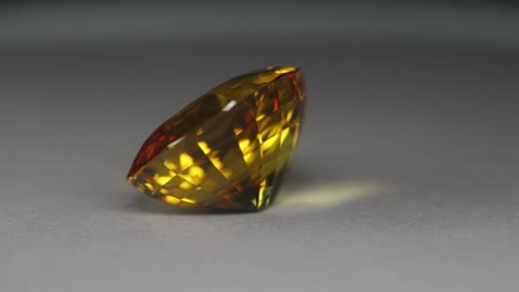 Polished-yellow-gemstone-rotates-and-sparkles