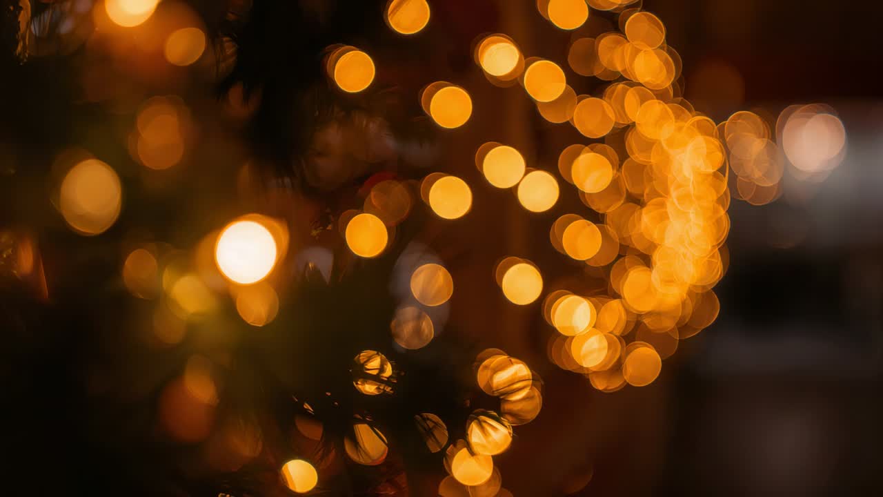 Shifting camera focus revealing warm yellow lights and garland at home, for cozy festive mood