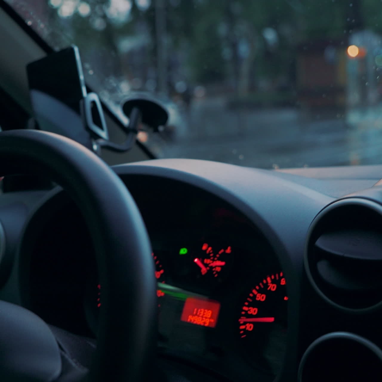 Driving a car in traffic jam in bad weather conditions. Hand of man driving a car. Close-up
