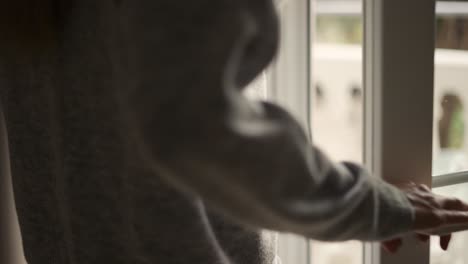 Woman-opening-curtains-in-hotel-room-going-out-on-the-balcony,-close-up