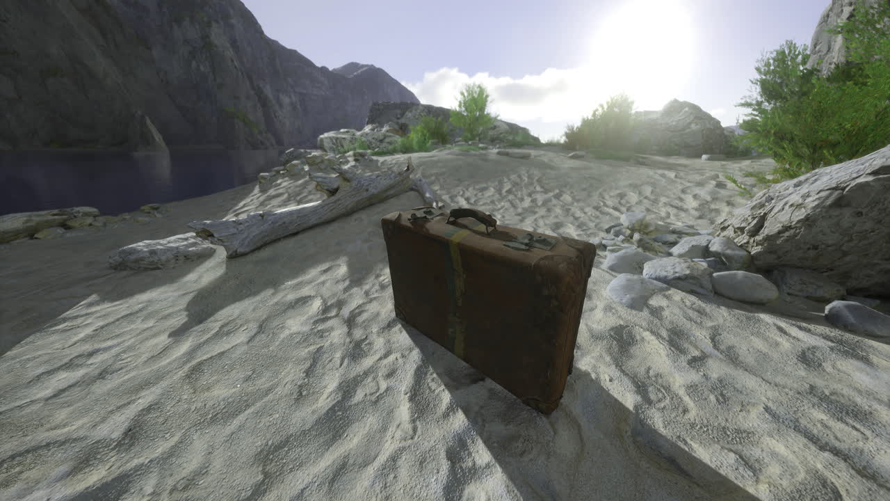 Old suitcase on sandy shore mountains behind and sun shining