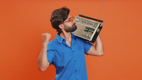 Man-using-retro-tape-record-player-to-listen-music-disco-dancing-of-favorite-track-having-fun