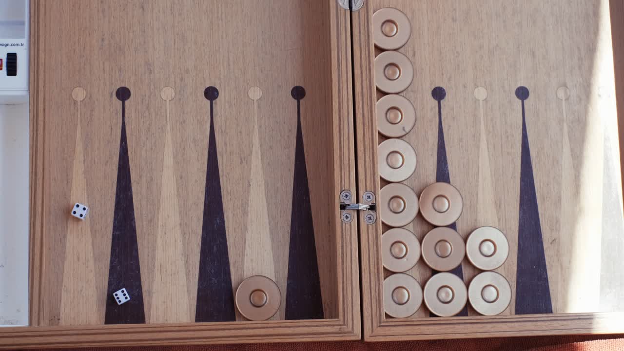 Woman playing backgammon and rolling dice