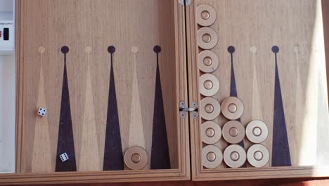 woman playing backgammon and rolling dice