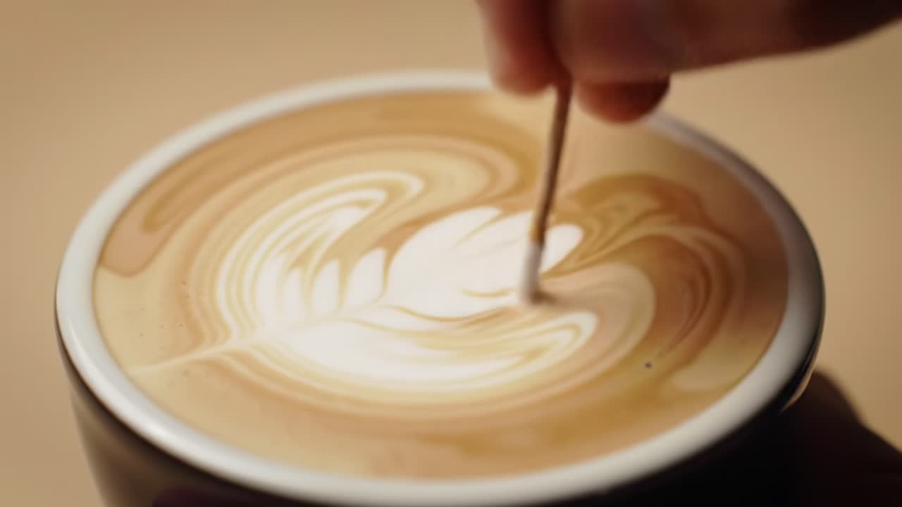 Creating a Beautiful Latte Art Design: The Process of Steady Hand Movements and Skillful Techniques in Coffee Preparation and Presentation