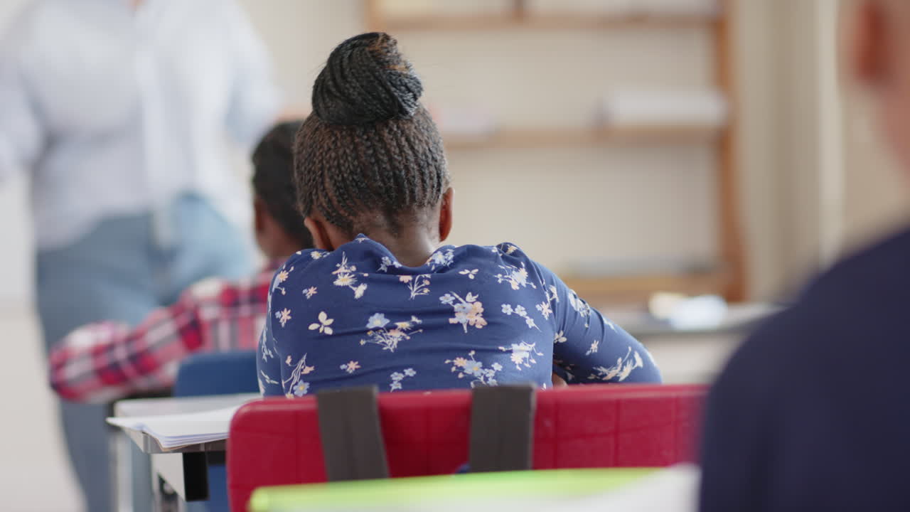 In school, student sitting at desk and focusing on classroom activities