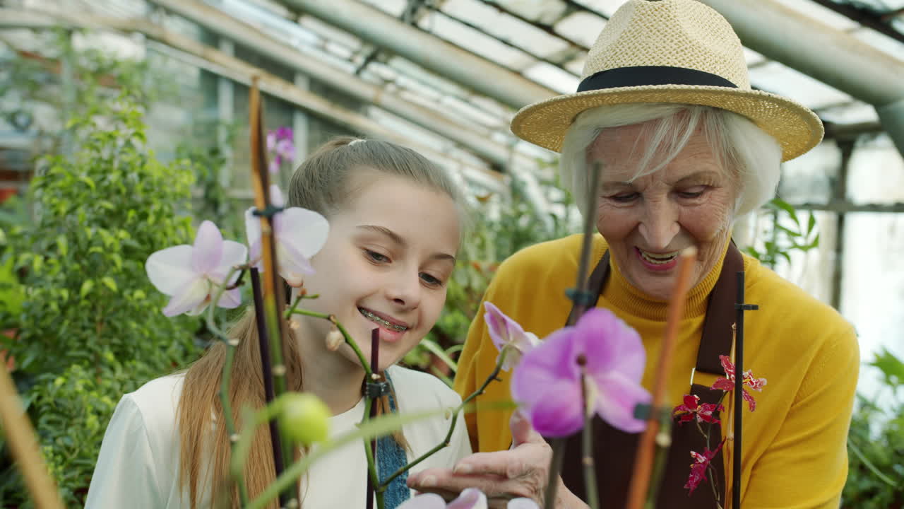 Granddaughter and Grandma in a Greenhouse