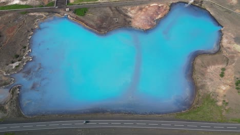 Scenic-drive-past-charming-sapphire-blue-lake-in-northeast-Iceland