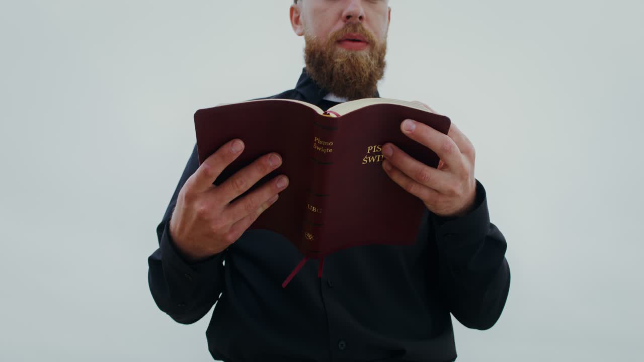 A priest reads a bible