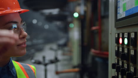 Woman-supervisor-looking-modern-factory-machine-screen-at-facility-closeup