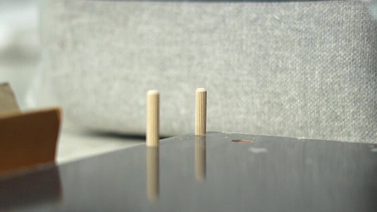 inserting screws in wooden table assemble diy closeup shot