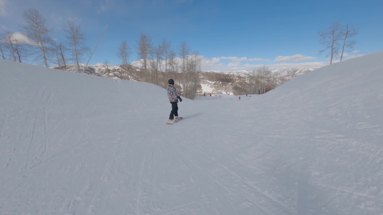 Man snowboarder performing snowboard tricks, Aspen, Colorado. Extreme sports concept